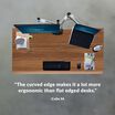 colin m. stated the curved edge makes it a lot more ergonomic than flat edged desks under an overhead image of a desk